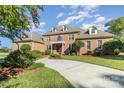 Beautiful brick home with a circular driveway, mature landscaping, and a well-maintained front yard at 150 Northchase Dr, Concord, NC 28027