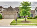 Charming brick home with a well-manicured lawn and a mature tree, complemented by a two-car garage at 15927 Vale Ridge Dr, Charlotte, NC 28278