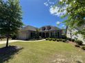 Charming brick home with lush front lawn, mature trees, and tidy landscaping at 15927 Vale Ridge Dr, Charlotte, NC 28278