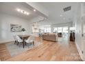 Bright open-concept living space features wood floors and seamlessly connects the dining, kitchen, and living areas at 15927 Vale Ridge Dr, Charlotte, NC 28278