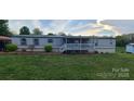 Inviting single-story home with a covered front porch and lush green lawn at 181 Trivette Rd, Harmony, NC 28634