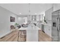 Bright, modern kitchen with a large island, stainless steel appliances, white cabinetry, and stylish pendant lighting at 1829 Jennings St, Charlotte, NC 28216