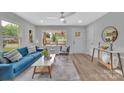 Sun-filled living room features wood floors, neutral walls, a large window view and stylish furnishings at 1829 Jennings St, Charlotte, NC 28216