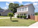 Inviting home with manicured lawn, fresh mulch and established shrubs at 197 Devon Forest Dr, Mooresville, NC 28115