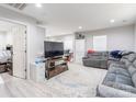 Spacious living room with modern gray sectional, large TV, and bright, neutral decor at 211 E Mcneely Ave, Mooresville, NC 28115