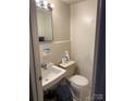 Cozy bathroom featuring a toilet, sink, mirror, and clean design offering a comfortable and private space at 2224 Yorkhills Dr # 7, Charlotte, NC 28217