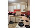 Functional kitchen with white cabinets, contrasting countertops and modern appliances is perfect for preparing any meal at 2224 Yorkhills Dr # 7, Charlotte, NC 28217