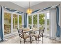 Inviting breakfast nook area with lake views and stylish chandelier lighting at 235 Pebble Point Rd, Salisbury, NC 28146
