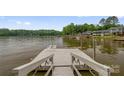 Picturesque dock with seating offering stunning lake views and direct water access for recreational activities at 235 Pebble Point Rd, Salisbury, NC 28146