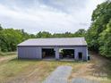 Spacious metal garage with multiple bays, perfect for storage or a workshop on this property at 2500 Cedar Cove Dr, Harrisburg, NC 28075