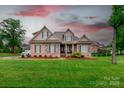 Charming single-Gathering home with manicured lawn, brick and stone facade, and inviting front porch at 335 Wintergreen Ct, Kings Mountain, NC 28086