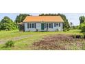 Well-maintained home featuring a green front door, complementary shutters, and attractive, low-maintenance landscaping at 35 Telephone Exchange Rd, Hickory, NC 28601