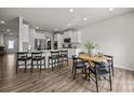 Bright, eat-in kitchen with wood floors, white cabinets, a center island and stainless appliances at 3643 Slider Ter, Lancaster, SC 29720