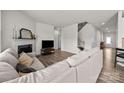 Spacious living room with wood floors, a fireplace, and stairs to the next level at 3643 Slider Ter, Lancaster, SC 29720