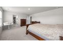 Neutral main bedroom featuring carpet floors, walk-in closet, and wooden furniture at 3643 Slider Ter, Lancaster, SC 29720