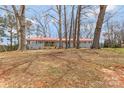 Charming one-story home with red roof and brick facade sitting on a grassy lot at 4566 Fork Rd, Norwood, NC 28128