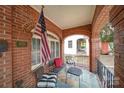 Relaxing front porch with comfortable seating and patriotic decor at 501 Pee Dee Ave, Albemarle, NC 28001