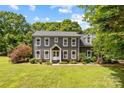 Charming two-story home featuring a lush green lawn and freshly planted landscaping at 5229 Mt Holly Huntersville Rd, Charlotte, NC 28216