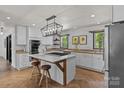 Modern kitchen features a large island, state-of-the-art appliances, and unique light fixture at 5229 Mt Holly Huntersville Rd, Charlotte, NC 28216