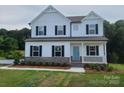 Charming two-story home with a welcoming front porch and classic architectural details at 5630 Galloway Dr # 49, Stanfield, NC 28163
