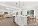 Open-concept kitchen with island overlooking a spacious living area with hardwood floors at 5630 Galloway Dr # 49, Stanfield, NC 28163