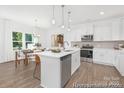 Bright kitchen featuring an island with sink, stainless appliances, and an adjacent dining area at 5630 Galloway Dr # 49, Stanfield, NC 28163