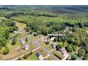 Aerial view of the property in a wooded neighborhood with tree coverage at 5678 Cedar Run Dr, Denver, NC 28037