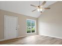 Bright, airy living room featuring wood floors, a ceiling fan, and a large window with natural light at 6022 Windsong Way, Wingate, NC 28174