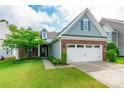 Beautiful front exterior with brick accents, a lush green lawn, and a welcoming two-car garage at 640 Mackenzie Falls Dr, Fort Mill, SC 29715