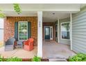 Inviting front porch with brick columns, seating area, and a view of the landscaped front yard at 640 Mackenzie Falls Dr, Fort Mill, SC 29715