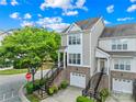 Exterior shot of a two-story townhome showcasing its brick foundation, garage, and inviting entryway steps at 6429 Terrace View Ct, Charlotte, NC 28269