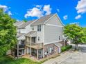 Exterior rear of a two-story townhome featuring upper and lower wooden decks, complemented by green landscaping at 6429 Terrace View Ct, Charlotte, NC 28269