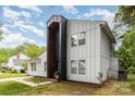 Beautifully landscaped exterior of a two-story home with white siding, a black entryway, and a walkway at 6824 Cortez Trl, Charlotte, NC 28227