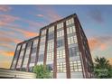 Exterior view of building, featuring brickwork, industrial-style windows, and architectural details at 715 N Graham St # 603, Charlotte, NC 28202
