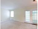 Bright living room with neutral carpet and sliding glass doors to outside at 723 Rabun Ln, Rock Hill, SC 29730