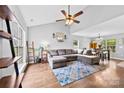 Open-concept living room with hardwood floors and vaulted ceilings at 7321 Mapleridge Dr, Charlotte, NC 28210