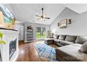 Bright living room with fireplace, hardwood floors, and large window at 7321 Mapleridge Dr, Charlotte, NC 28210