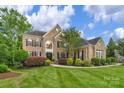Attractive brick house showcasing a well-kept lawn, professional landscaping, and classic architectural details at 7501 Cleyera Cir, Waxhaw, NC 28173
