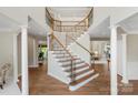 Grand foyer features a stunning staircase with iron railings and elegant architectural details at 7501 Cleyera Cir, Waxhaw, NC 28173
