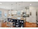 A stylish kitchen featuring a large center island, stainless steel appliances, and a bright breakfast nook at 10401 Royal Winchester Dr, Charlotte, NC 28277