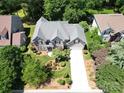 Aerial view of a meticulously landscaped home with a long private driveway at 10616 Back Ridge Rd, Charlotte, NC 28277