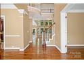 Bright foyer showcasing hardwood floors and a staircase leading to a second level at 10616 Back Ridge Rd, Charlotte, NC 28277