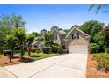 Charming brick home with well-manicured landscaping and a long driveway at 10616 Back Ridge Rd, Charlotte, NC 28277