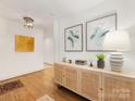 Tastefully decorated entryway with hardwood floors, modern light fixture, and stylish console table at 1300 Rutledge Ave, Charlotte, NC 28211