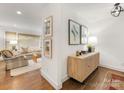 Bright entryway featuring hardwood floors, stylish console table with decor, and artwork at 1300 Rutledge Ave, Charlotte, NC 28211