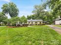 Beautiful exterior view of the home with lush green lawn, established trees and lovely curb appeal at 1300 Rutledge Ave, Charlotte, NC 28211