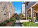 Multi-level backyard with a decorative stone stairway, lush greenery, and a patio at 1428 Spring Ridge Ln, Denver, NC 28037