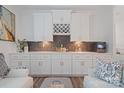 Stylish bar area with white cabinetry, dark backsplash, wine rack, and modern decor at 1428 Spring Ridge Ln, Denver, NC 28037