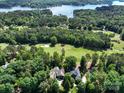 Stunning aerial view of a lakeside property with a lush golf course nearby surrounded by mature trees at 154 Patterson'S Bridge None, New London, NC 28127