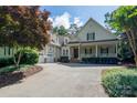 Charming two-story home featuring an attached garage, covered porch, and inviting curb appeal at 154 Patterson'S Bridge None, New London, NC 28127